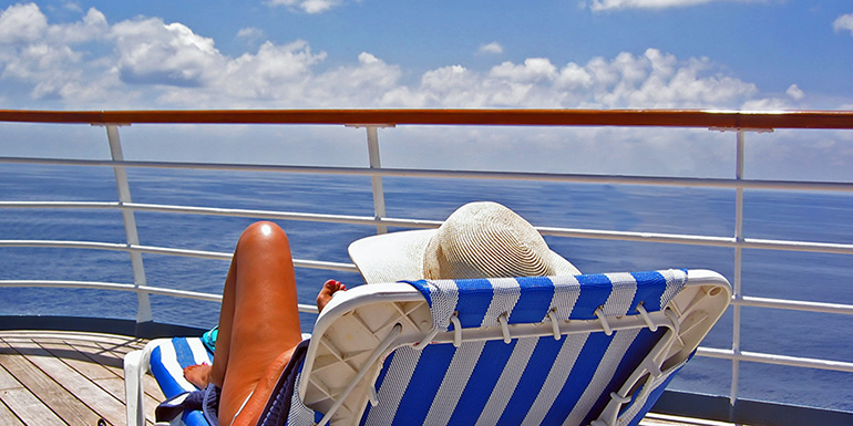 women-laying-on-chair-on-cruise-deck-770